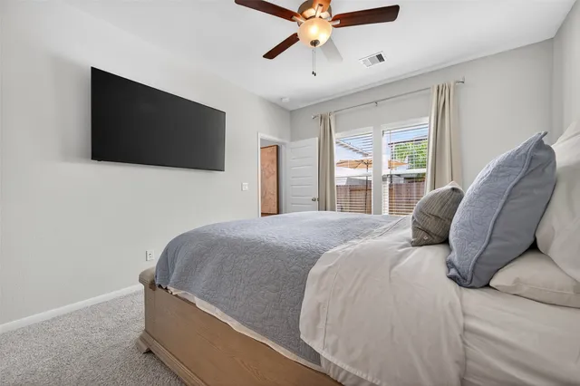 a bedroom with a large bed and a flat screen tv