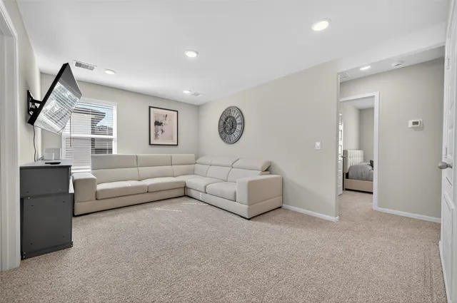 a living room with furniture and a wall painting