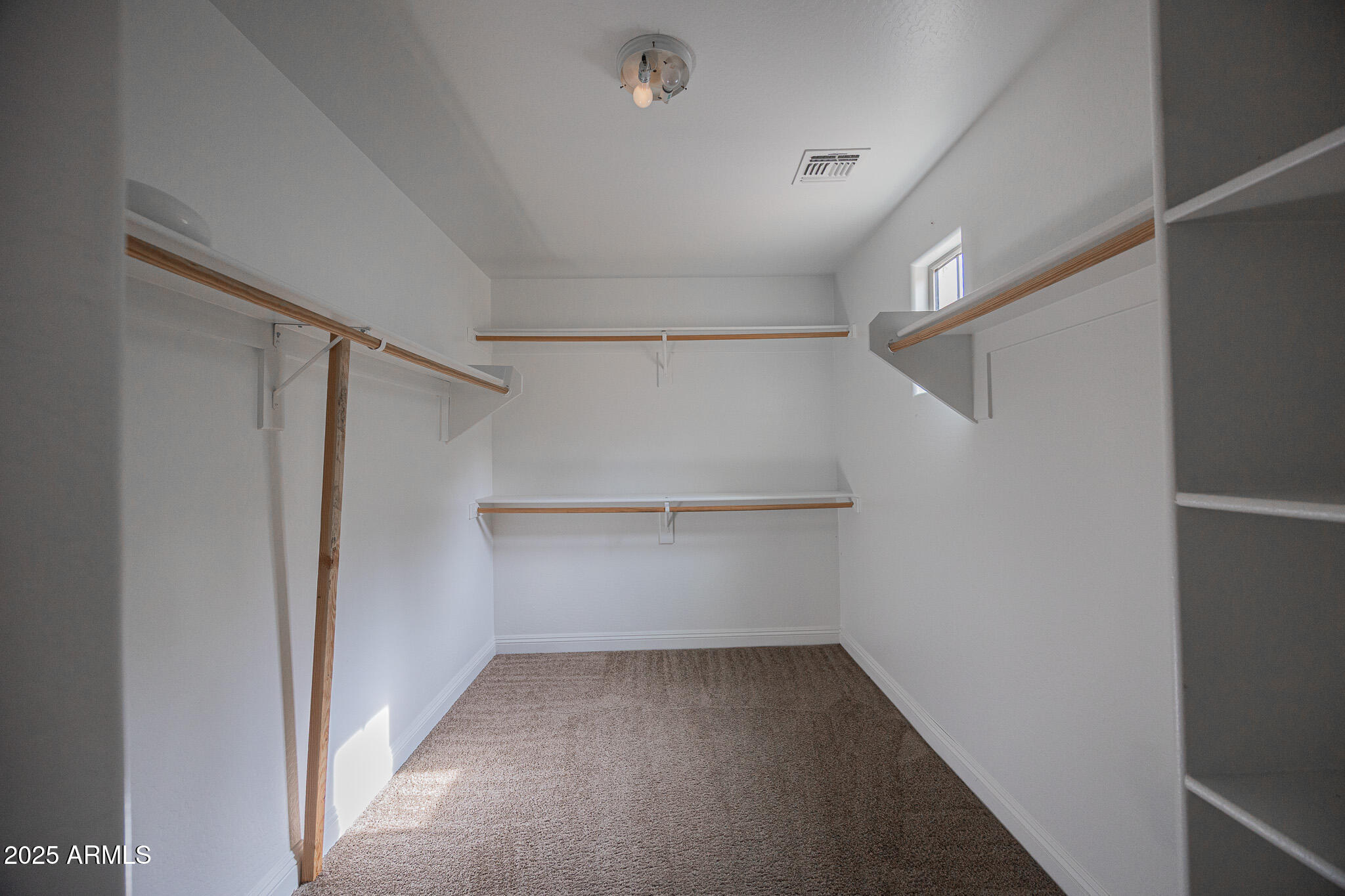 3314 East Sheffield Road Gilbert, AZ 85296 - Photo 17 of 31 a view of an empty walk in closet