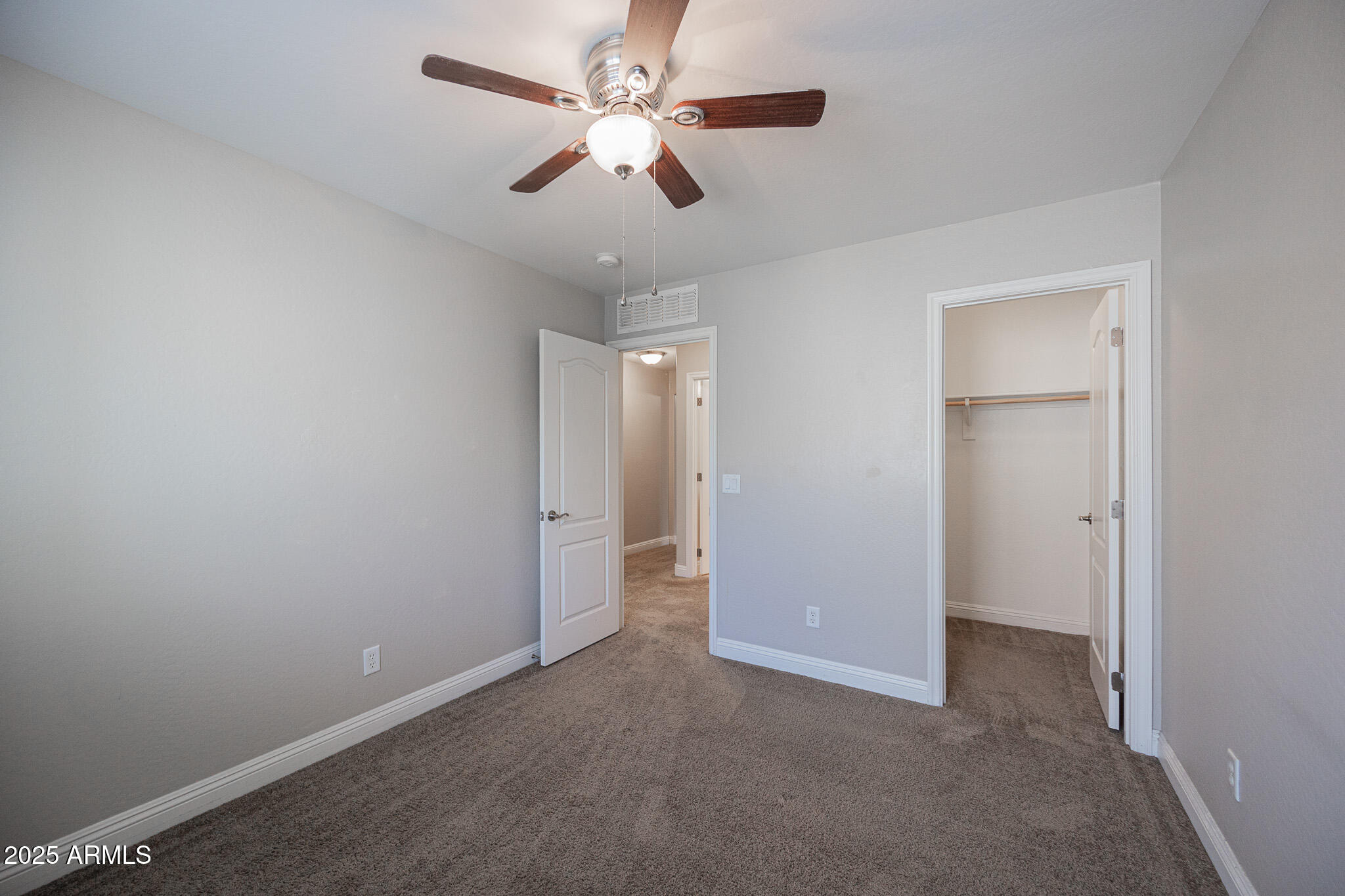 3314 East Sheffield Road Gilbert, AZ 85296 - Photo 21 of 31 an empty room with ceiling fan and window