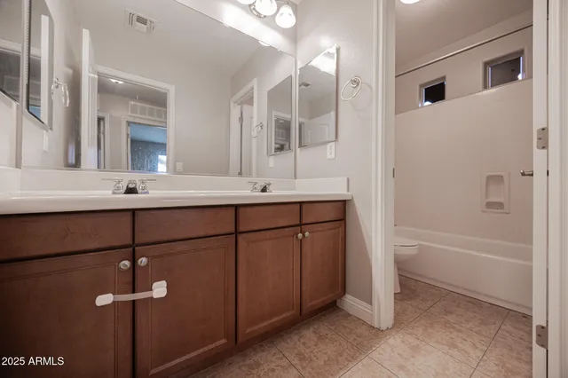a bathroom with a sink tub vanity and shower