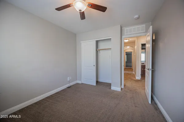 an empty room with a empty space and a ceiling fan