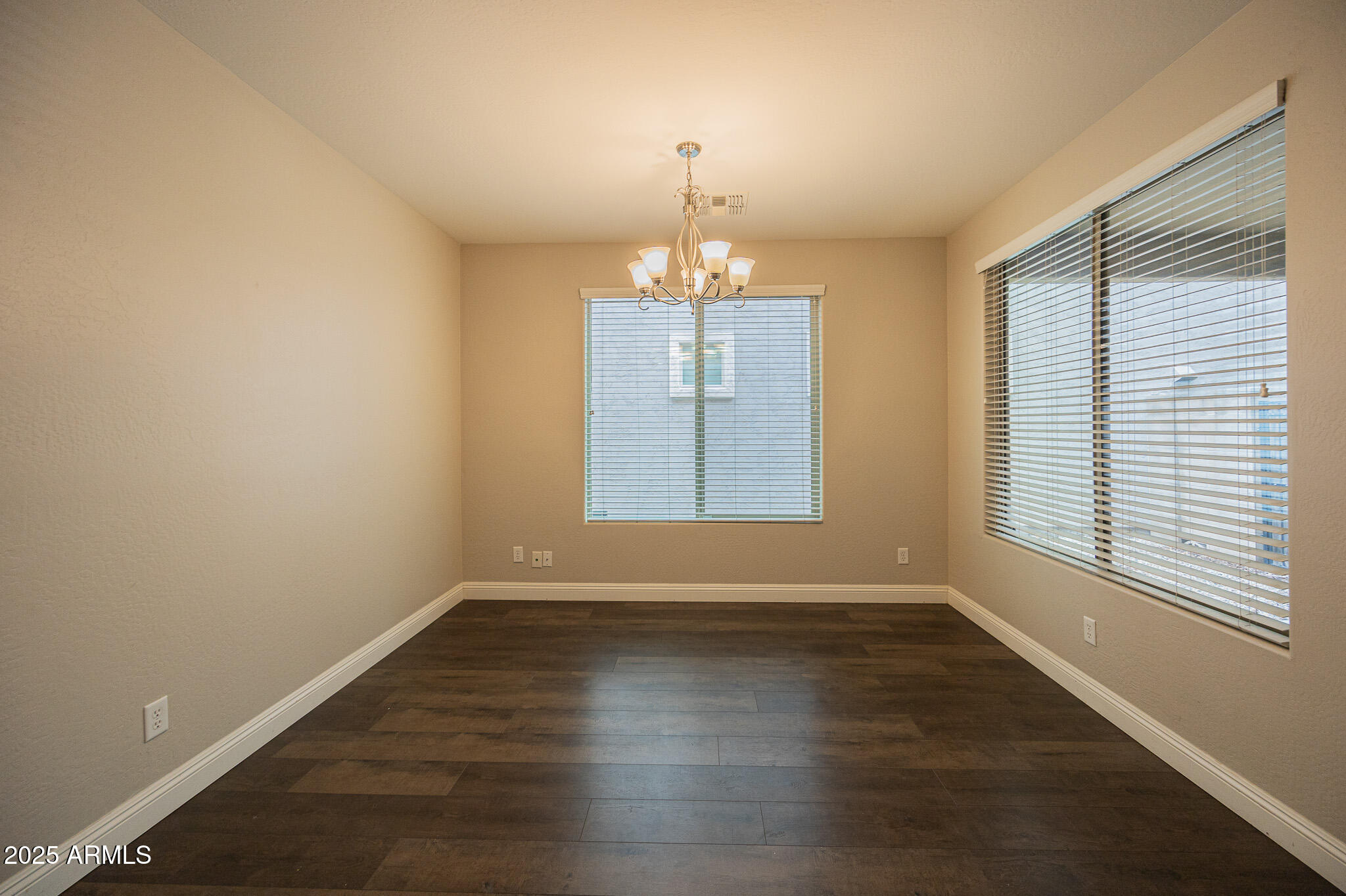 3314 East Sheffield Road Gilbert, AZ 85296 - Photo 10 of 31 an empty room with wooden floor and windows