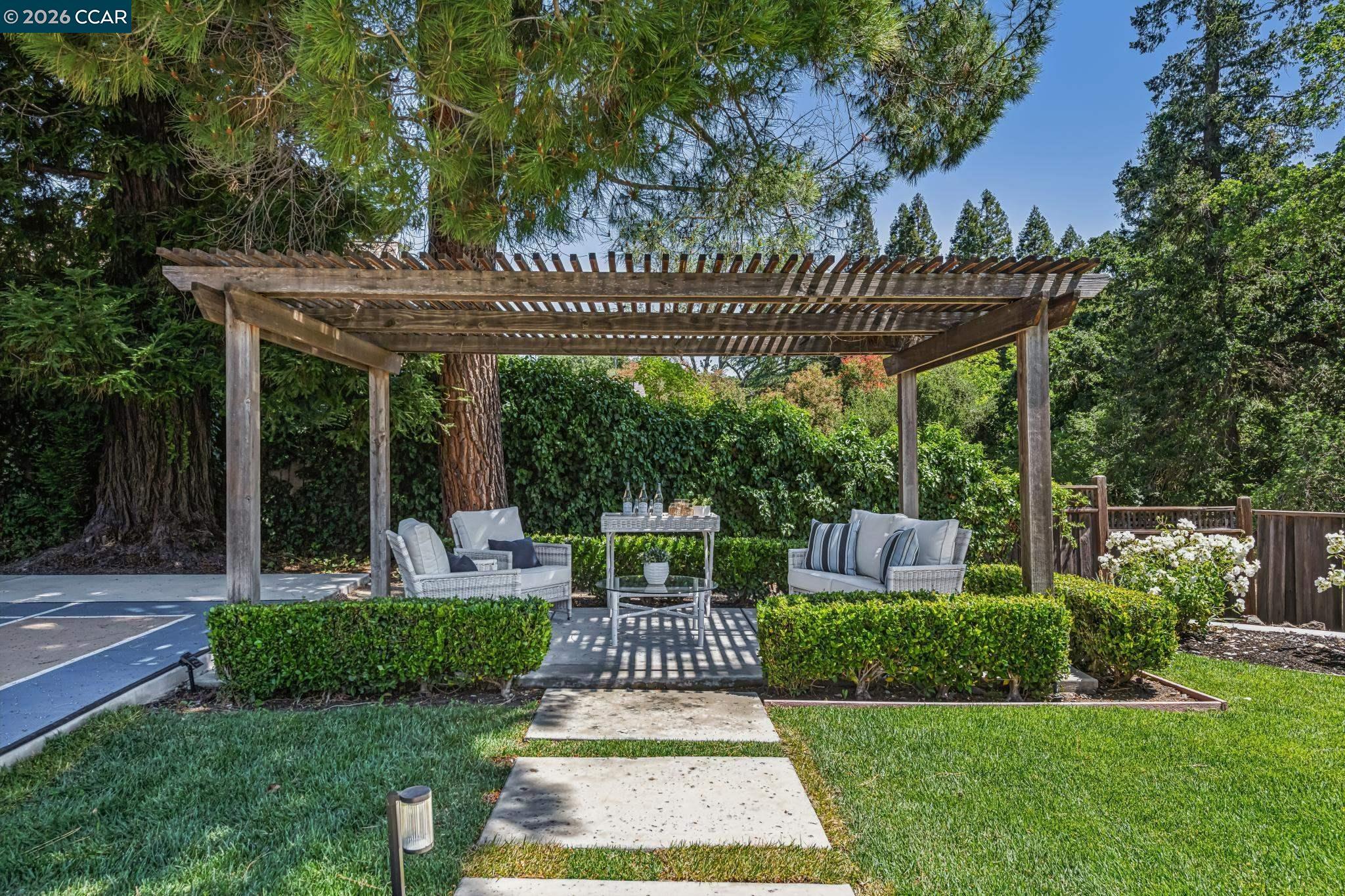 2941 Roundhill Road Alamo, CA 94507 - Photo 72 of 83 a view of a patio with couches chairs and a big yard