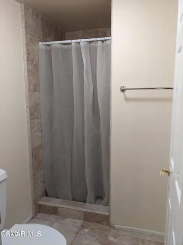 a bathroom with a shower and a tub