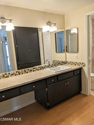 a bathroom with a double vanity sink and mirror