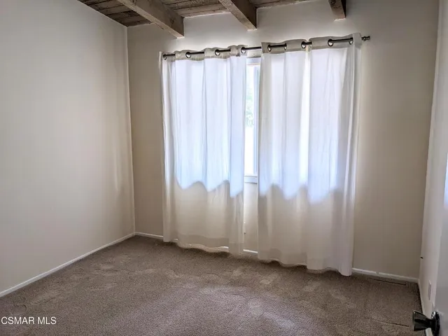 a view of a room with a window and a shower curtain