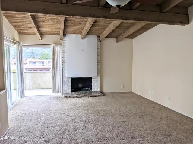a view of an empty room with a fireplace