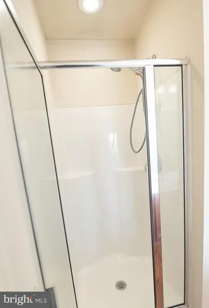 a bathroom with a glass shower door