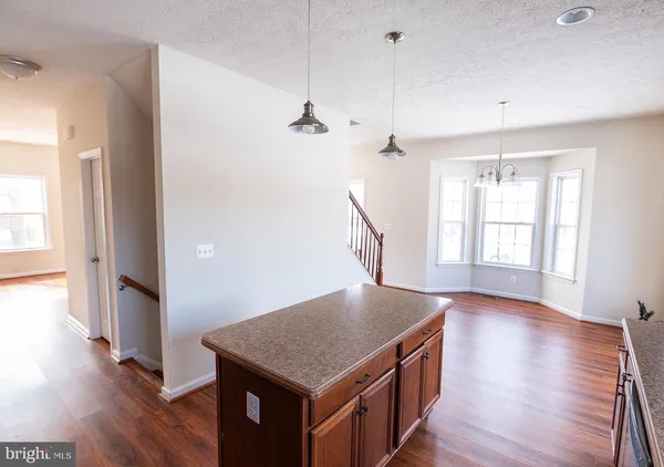 a kitchen with kitchen island window and wooden floor