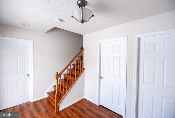 a view of an entryway with wooden floor