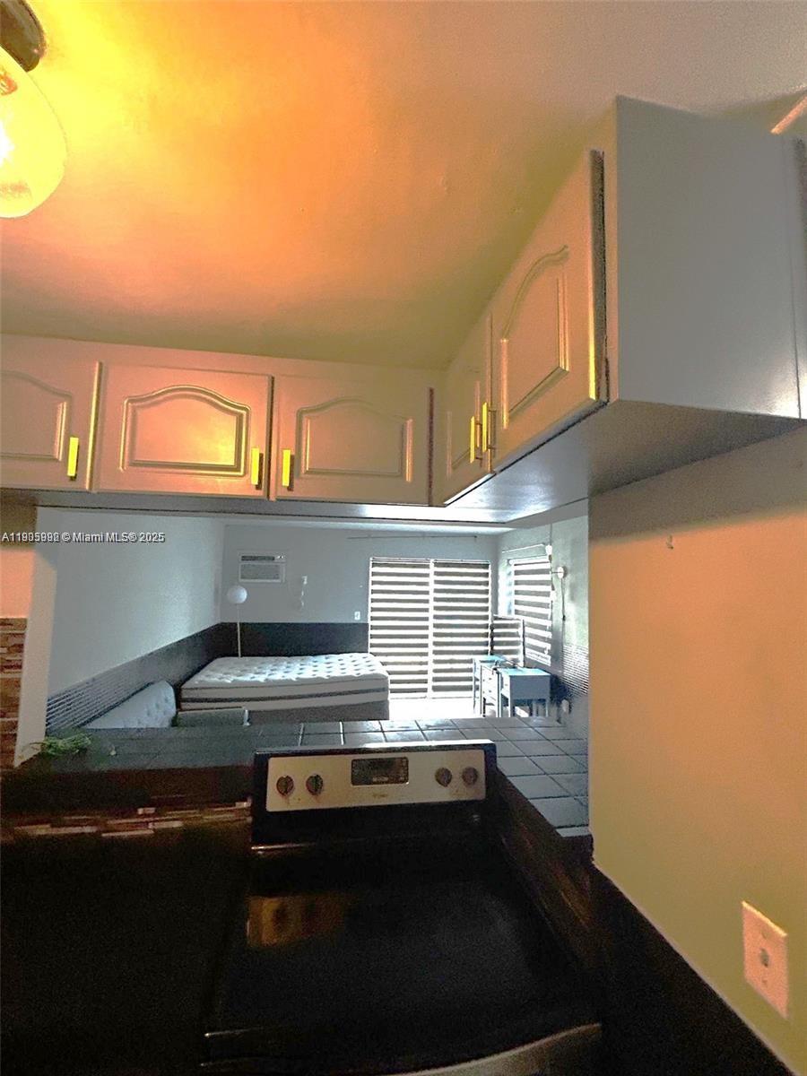 1441 Lincoln Road, Unit 217 Miami Beach, FL 33139 - Photo 5 of 15 a kitchen with a sink and a stove top oven