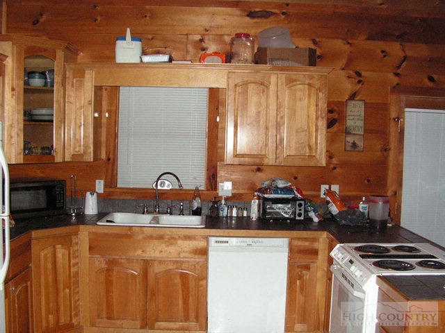 138 Sequoia Lane Boone, NC 28607 - Photo 22 of 26 a kitchen with stainless steel appliances granite countertop a stove a sink and a microwave