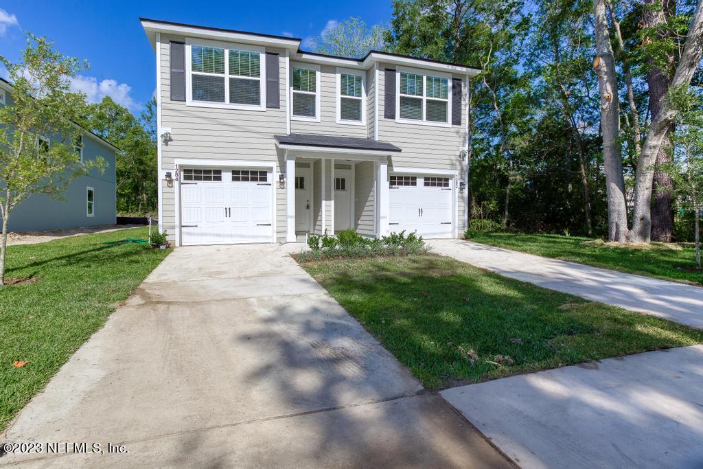 1330 Ellis Road South Jacksonville, FL 32205 - Photo 1 of 23 a front view of a house with a yard and trees