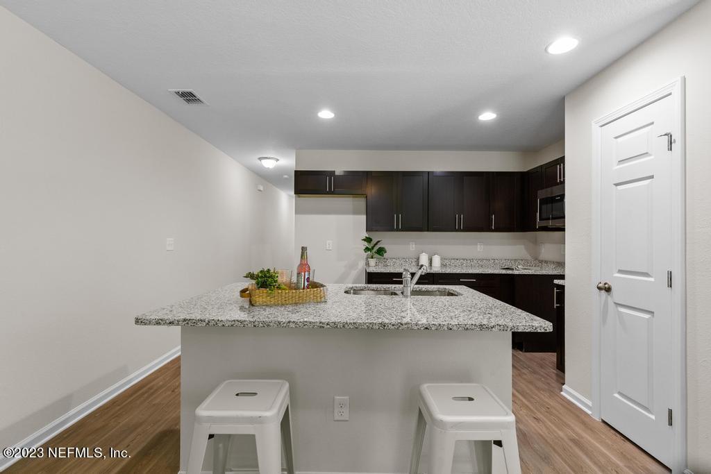 1330 Ellis Road South Jacksonville, FL 32205 - Photo 13 of 23 a kitchen with a sink a stove and cabinets