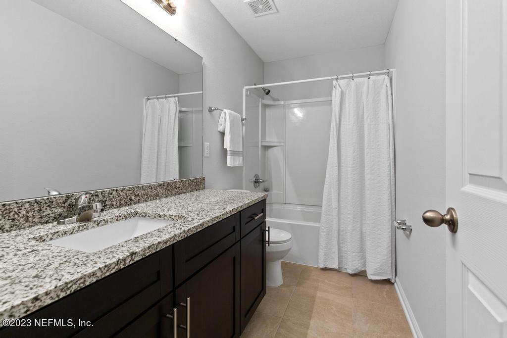 1330 Ellis Road South Jacksonville, FL 32205 - Photo 18 of 23 a bathroom with a granite countertop sink and a mirror
