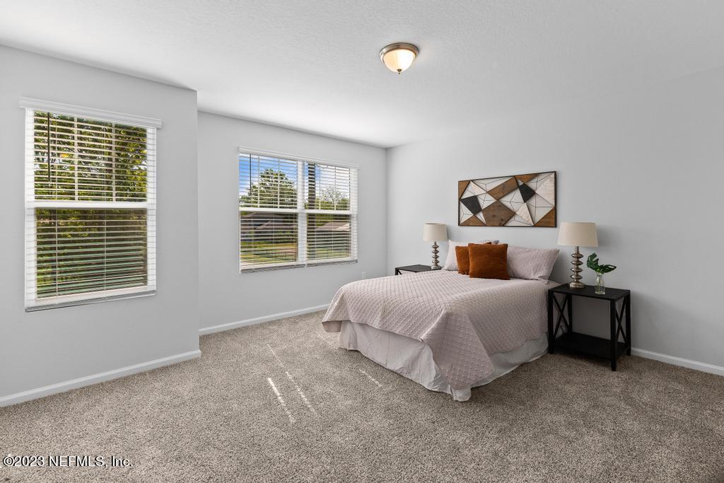 1330 Ellis Road South Jacksonville, FL 32205 - Photo 21 of 23 a bedroom with a bed lamp and a window