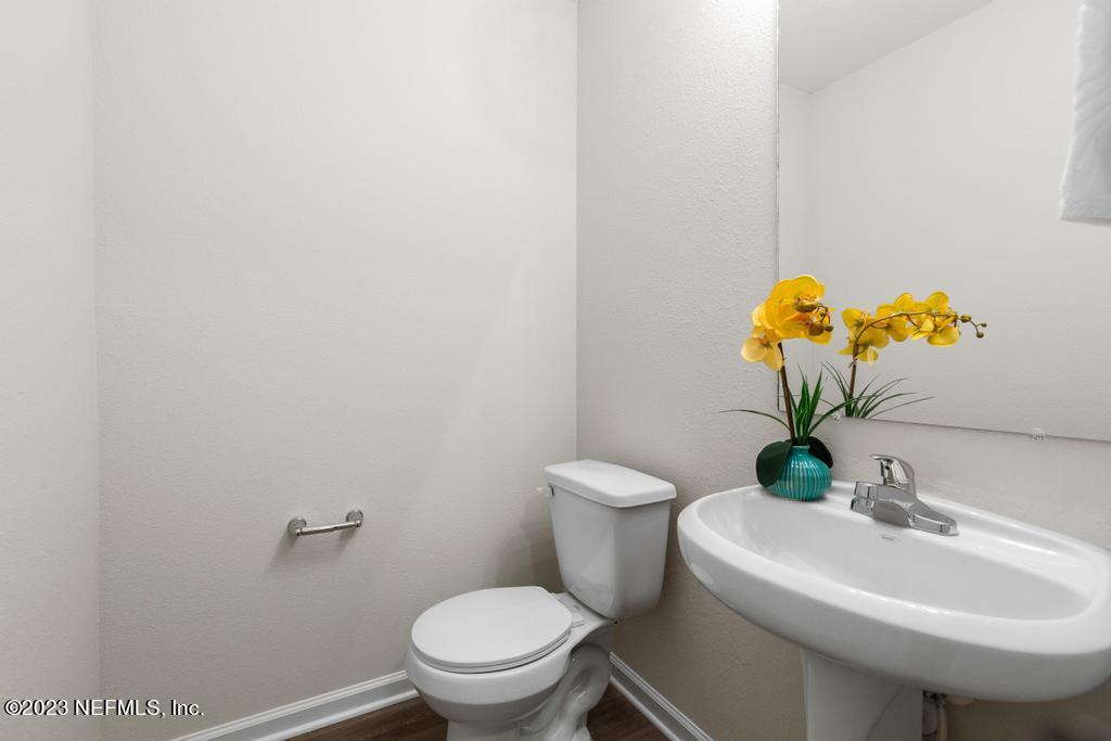 1330 Ellis Road South Jacksonville, FL 32205 - Photo 5 of 23 a bathroom with a sink mirror and toilet