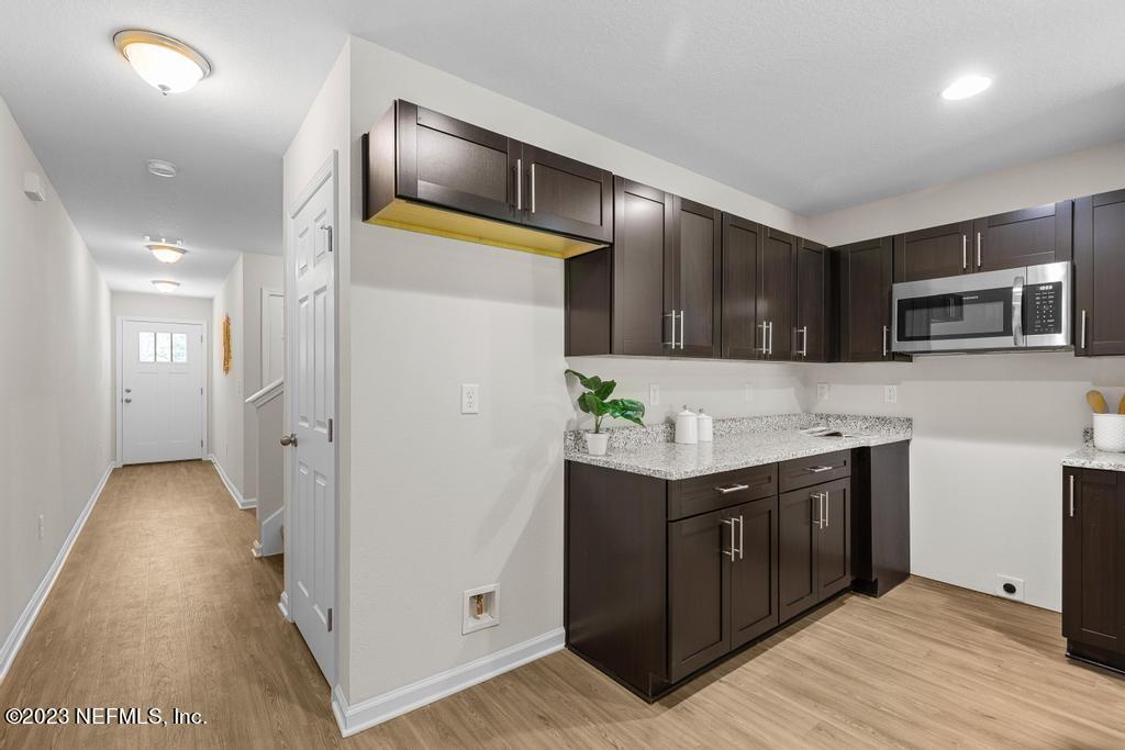 1330 Ellis Road South Jacksonville, FL 32205 - Photo 8 of 23 a kitchen with stainless steel appliances granite countertop a refrigerator and a stove