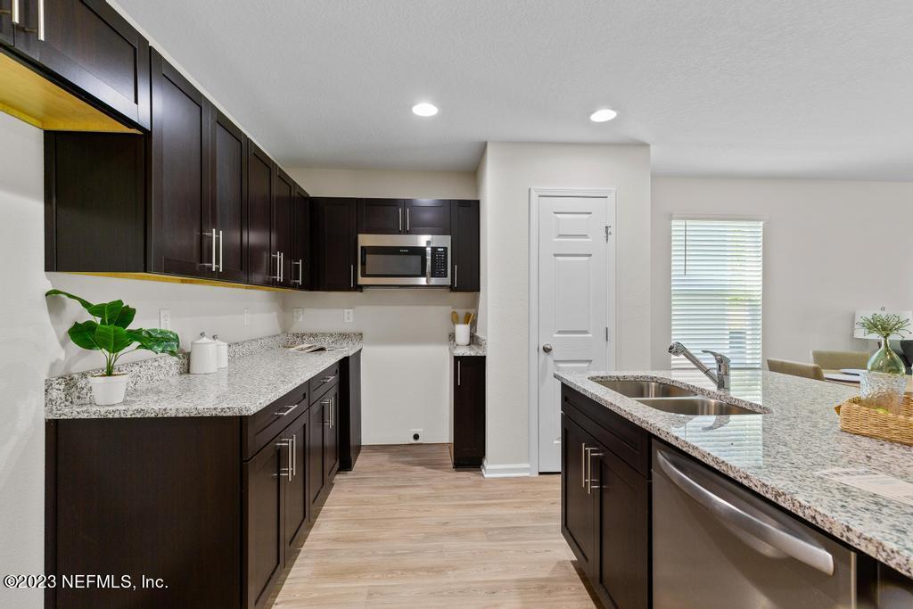 1330 Ellis Road South Jacksonville, FL 32205 - Photo 9 of 23 a kitchen with stainless steel appliances granite countertop a sink stove and refrigerator
