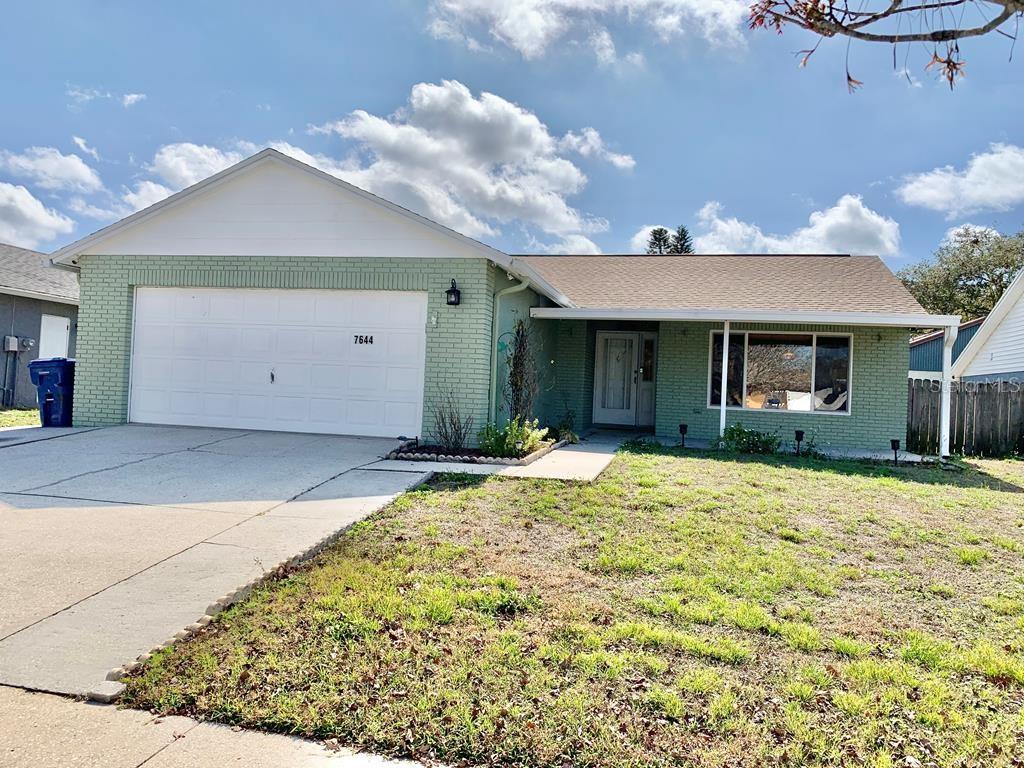 7644 Arlight Drive New Port Richey, FL 34655 - Photo 1 of 1 a front view of a house with a yard and garage