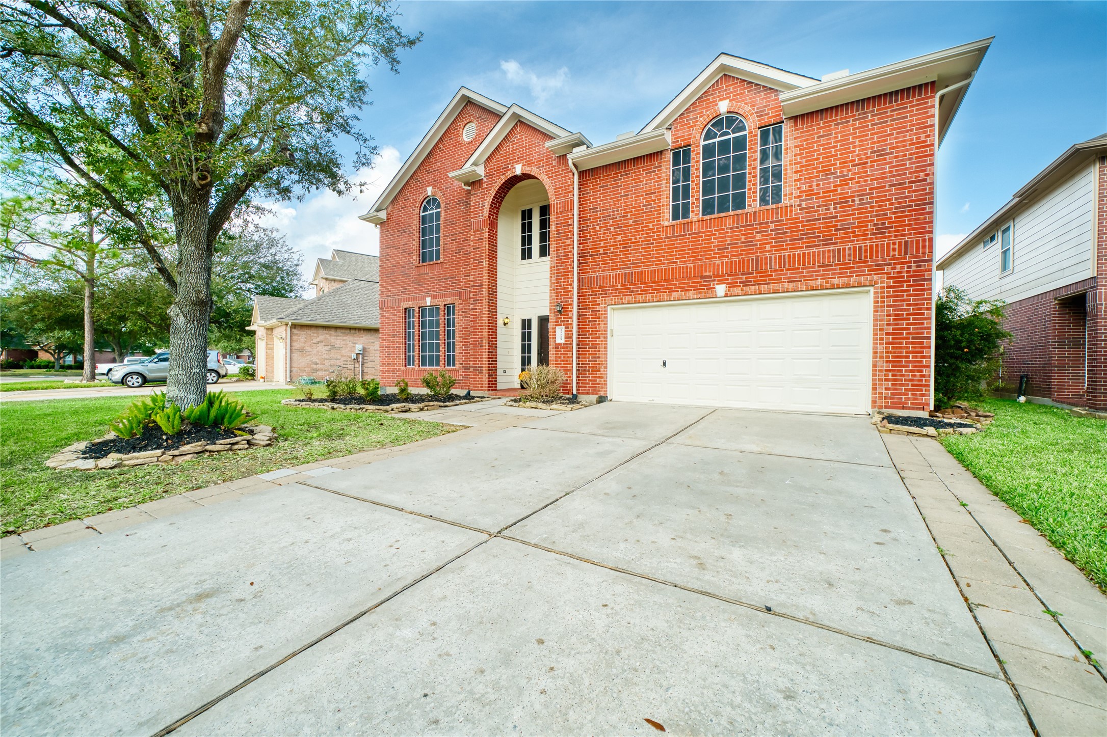 11115 Seminole Spring Lane Houston, TX 77089 - Photo 2 of 44 a front view of a house with a yard and garage