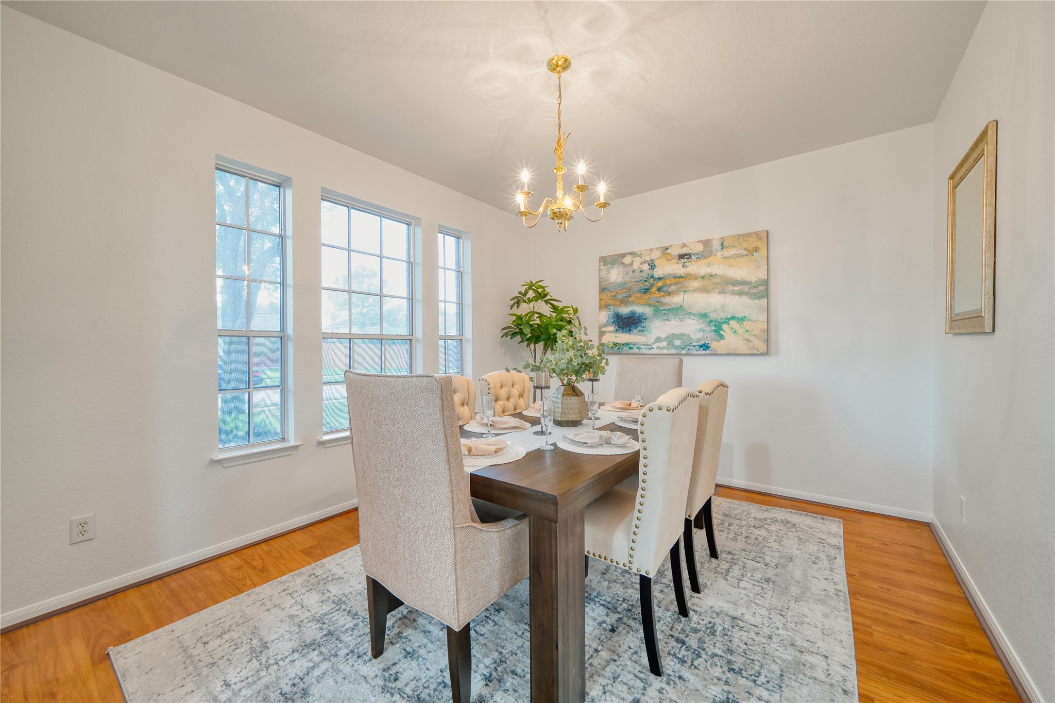 11115 Seminole Spring Lane Houston, TX 77089 - Photo 8 of 44 a view of a dining room with furniture a chandelier and wooden floor