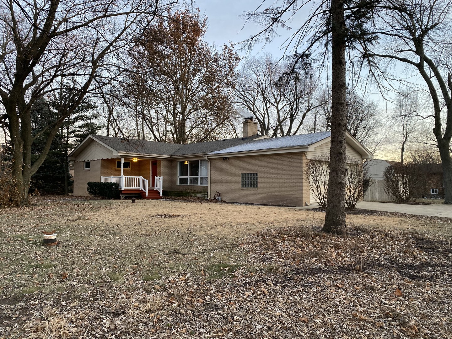a front view of house with yard and trees