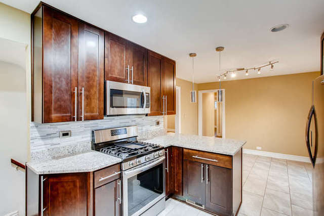 26W421 Geneva Road Wheaton, IL 60187 - Photo 12 of 29 a kitchen with stainless steel appliances granite countertop wooden cabinets and a stove top oven
