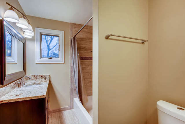 26W421 Geneva Road Wheaton, IL 60187 - Photo 19 of 29 a bathroom with a granite countertop sink and a mirror