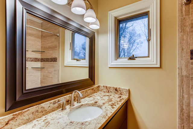26W421 Geneva Road Wheaton, IL 60187 - Photo 20 of 29 a bathroom with a granite countertop sink and a mirror