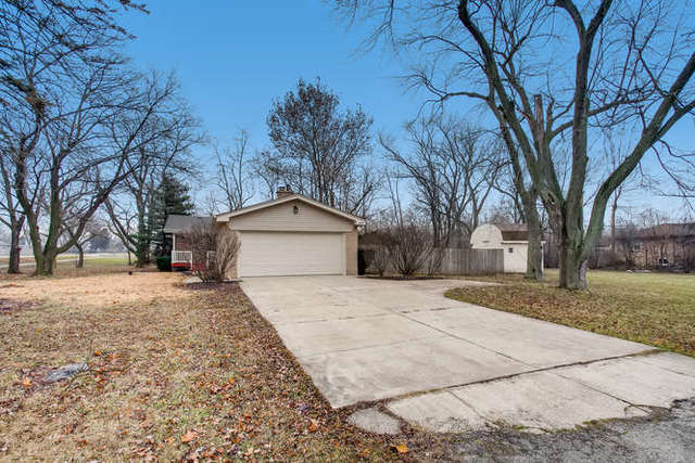 26W421 Geneva Road Wheaton, IL 60187 - Photo 4 of 29 a wooden house with trees in front of it