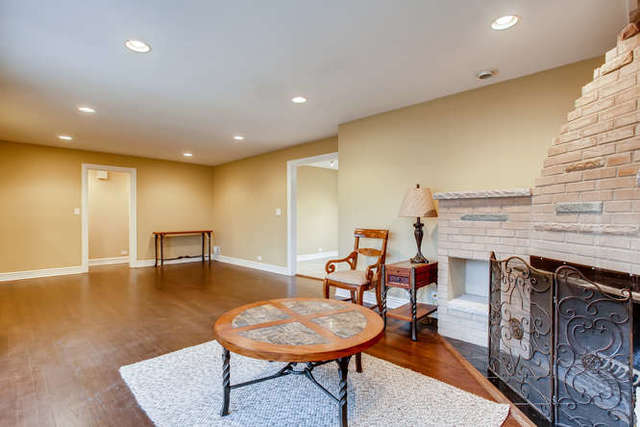 26W421 Geneva Road Wheaton, IL 60187 - Photo 8 of 29 a living room with fireplace furniture and a wooden floor