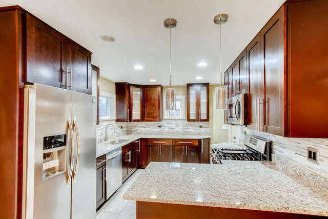 26W421 Geneva Road Wheaton, IL 60187 - Photo 10 of 29 a kitchen with stainless steel appliances granite countertop a sink refrigerator and cabinets