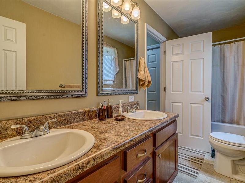 3460 Sterling Road Roanoke, VA 24014 - Photo 16 of 37 a bathroom with a granite countertop sink and a mirror