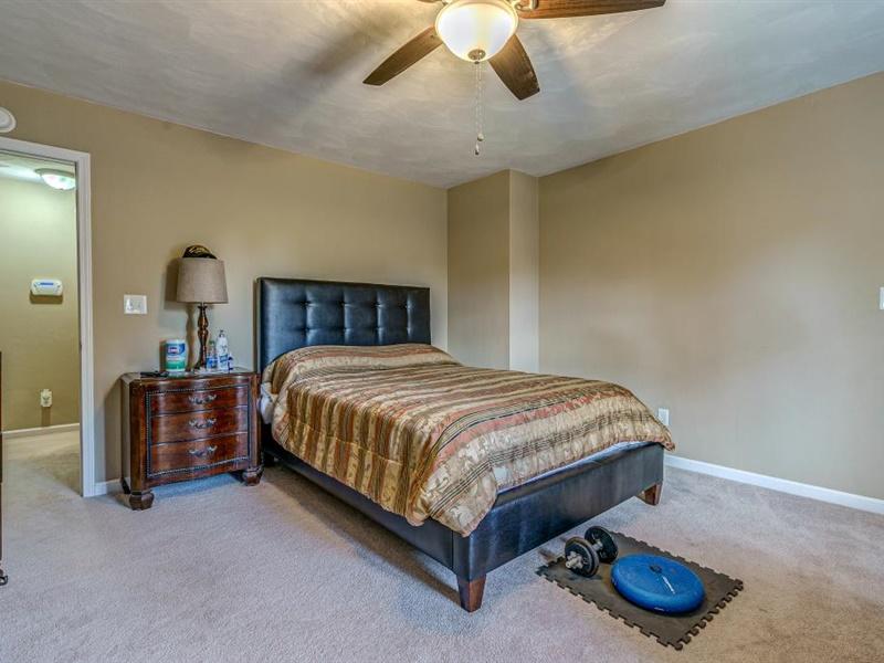 3460 Sterling Road Roanoke, VA 24014 - Photo 17 of 37 a bed sitting in a room next to a lamp and a chandelier