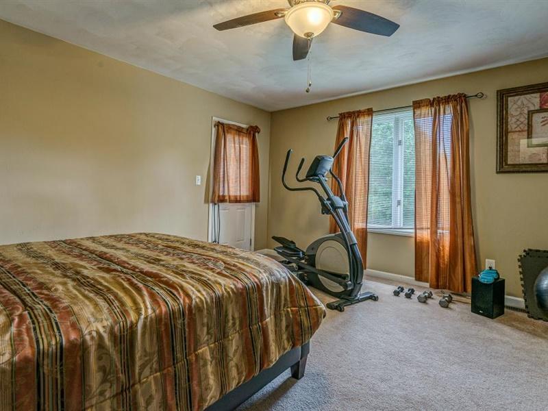 3460 Sterling Road Roanoke, VA 24014 - Photo 18 of 37 a bed sitting in a bedroom next to a window