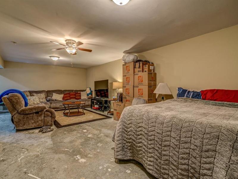 3460 Sterling Road Roanoke, VA 24014 - Photo 22 of 37 a spacious bedroom with a bed a couch and a chandelier