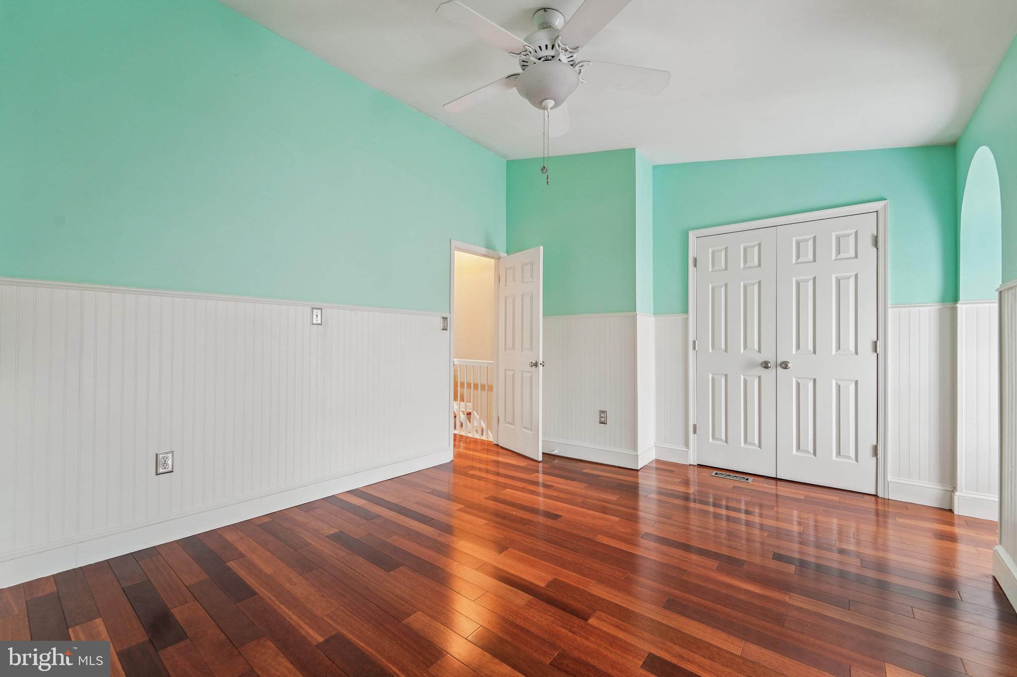 56 Victoria Square Frederick, MD 21702 - Photo 20 of 38 an empty room with wooden floor and fan