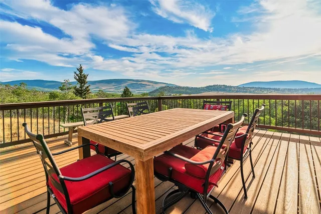a view of a balcony with lounge chairs