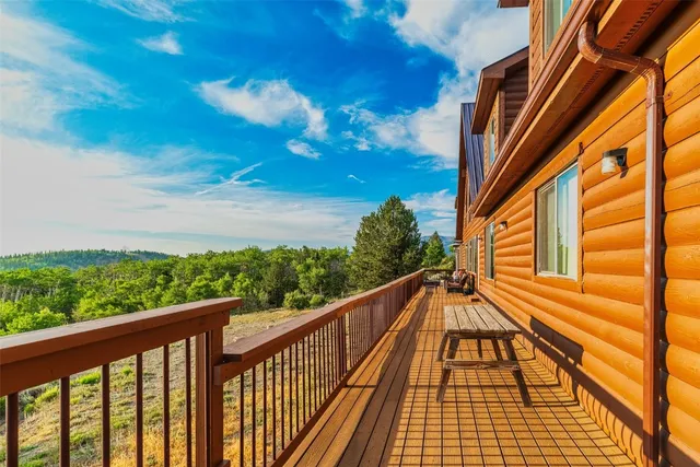 a view of a balcony with wooden floor and fence