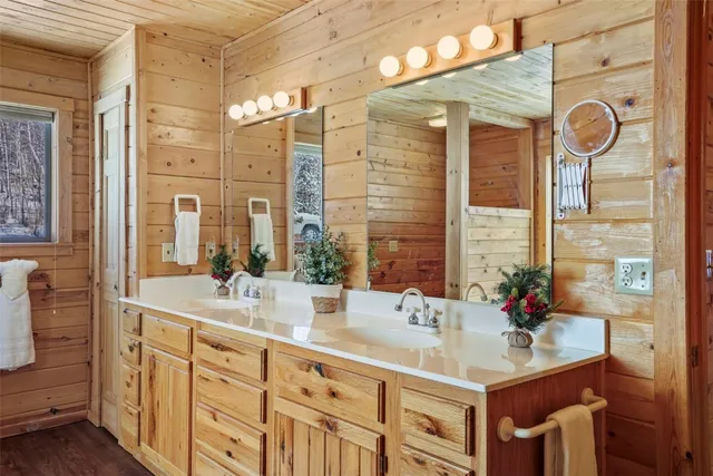 a bathroom with a sink double vanity and a mirror