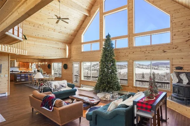 a living room with furniture and a floor to ceiling window