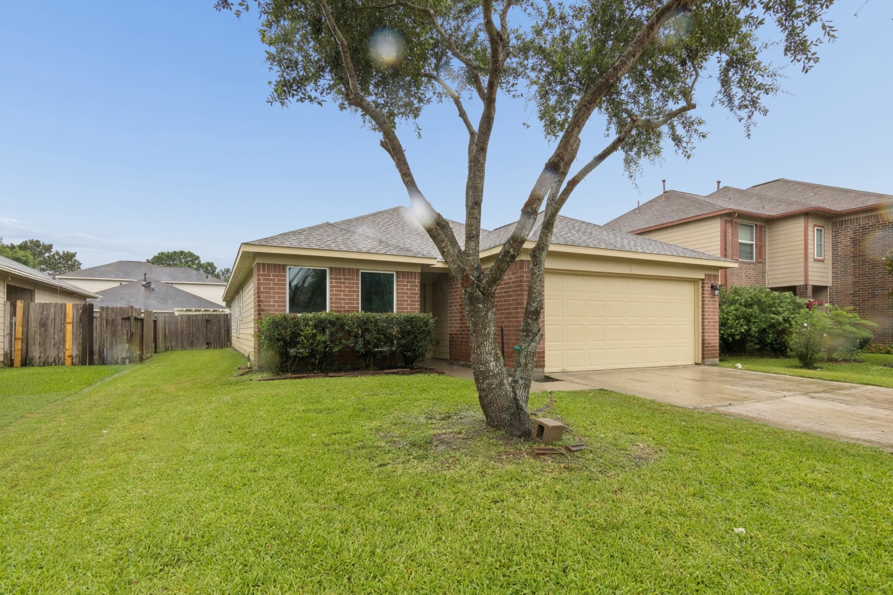 7811 Adonis Avenue Baytown, TX 77521 - Photo 4 of 36 a front view of a house with a yard and garage