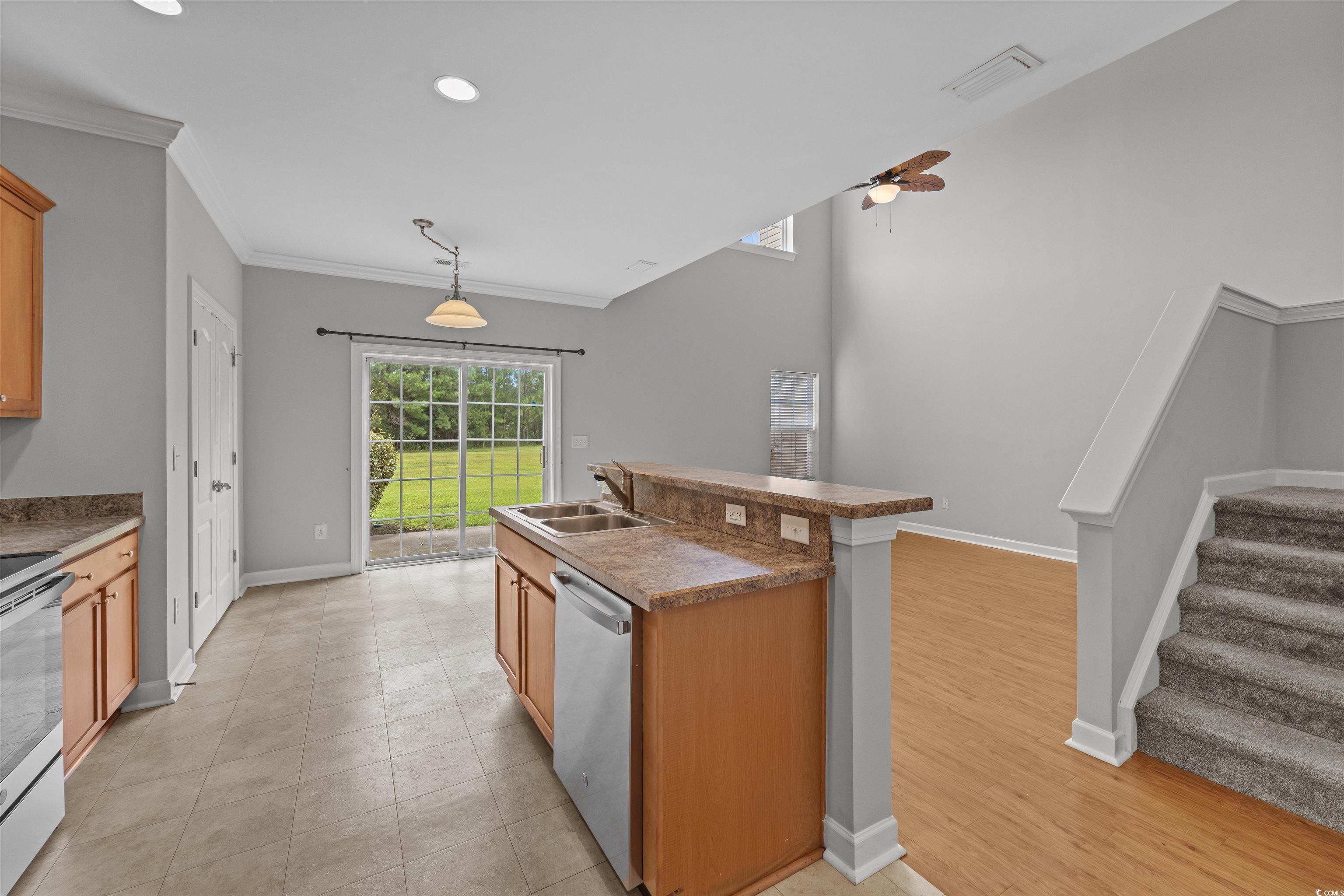 1060 Fairway Lane Conway, SC 29526 - Photo 12 of 32 Kitchen featuring a kitchen island with sink, electric range, crown molding, stainless steel dishwasher, and ceiling fan