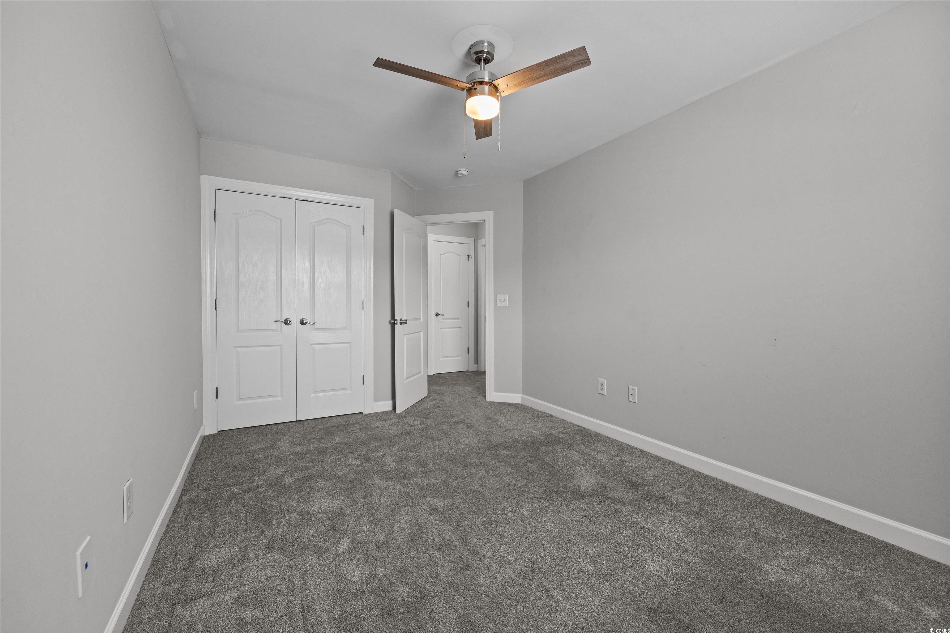 1060 Fairway Lane Conway, SC 29526 - Photo 16 of 32 Unfurnished bedroom with dark colored carpet, a closet, and ceiling fan