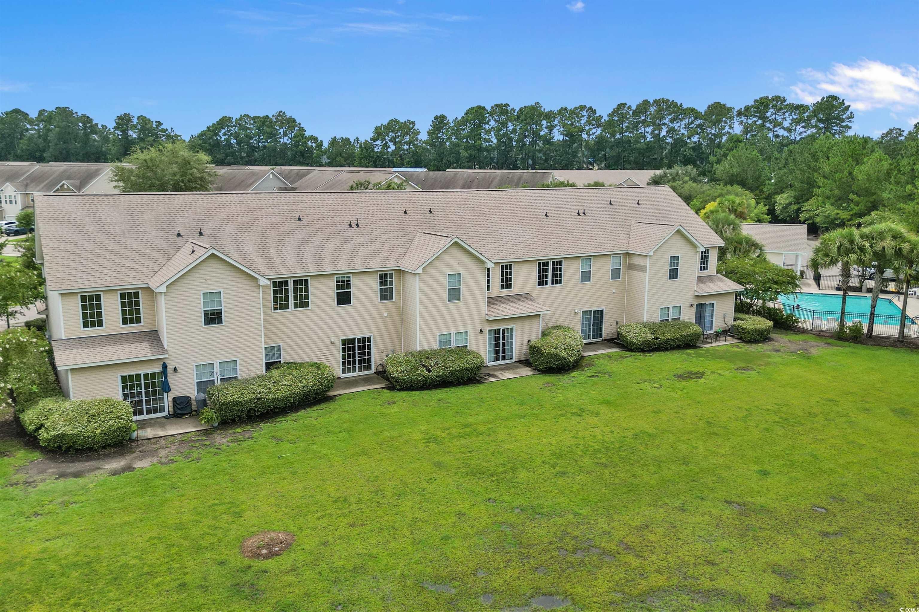 1060 Fairway Lane Conway, SC 29526 - Photo 28 of 32 Back of house featuring a patio, view of wooded area, and a lawn