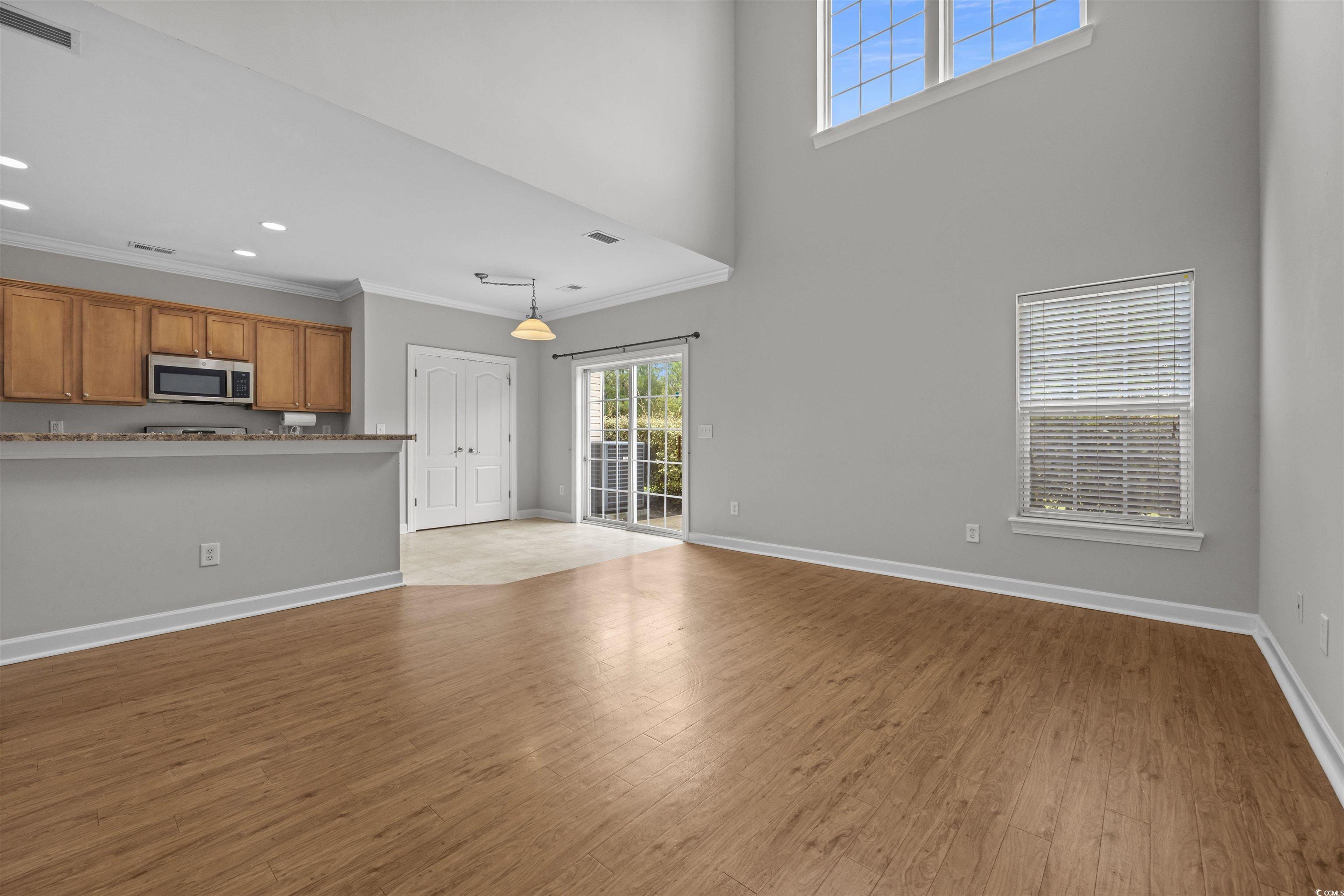 1060 Fairway Lane Conway, SC 29526 - Photo 5 of 32 Unfurnished living room with light wood-style floors, a high ceiling, crown molding, and recessed lighting