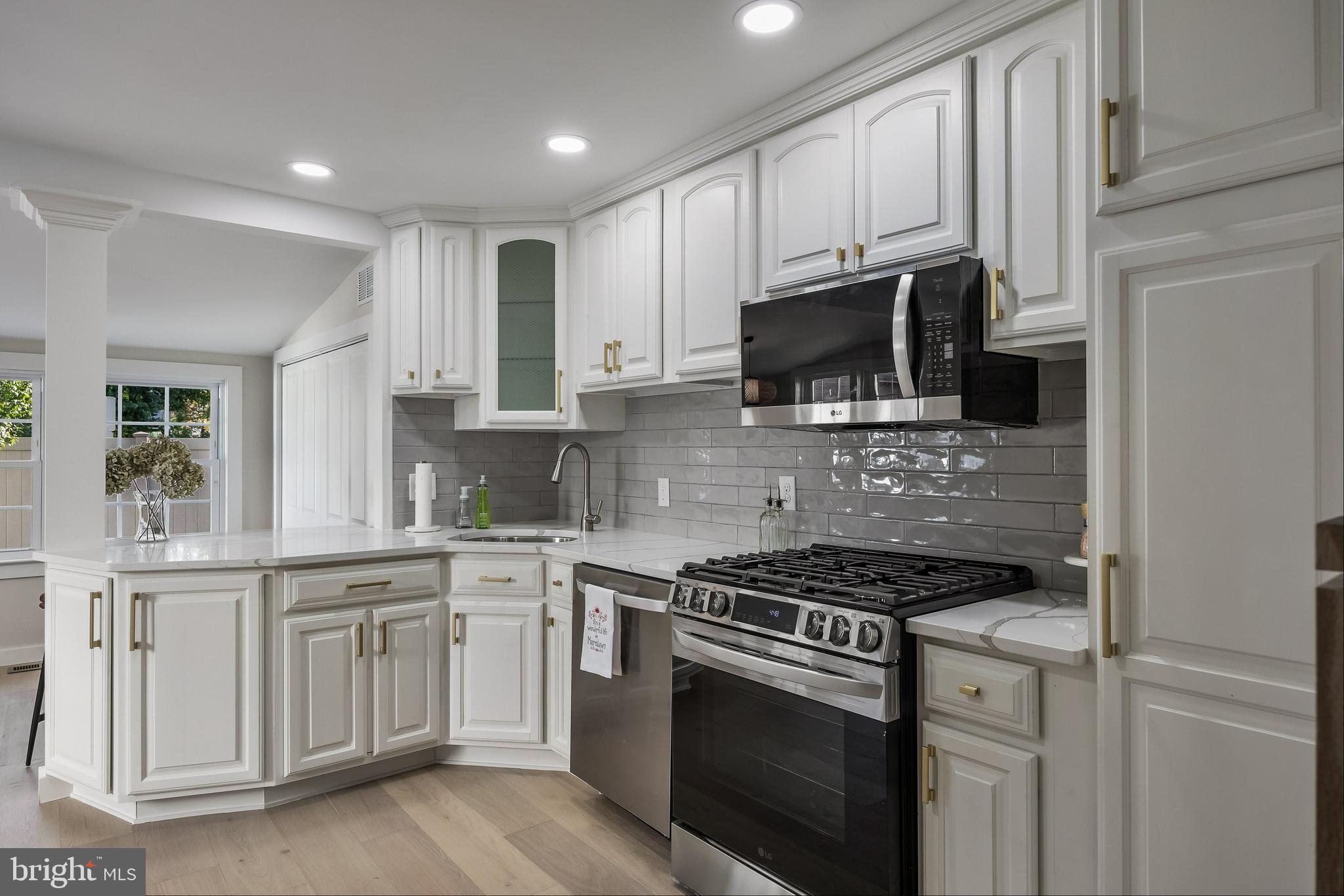 82 East 3rd Street Moorestown, NJ 08057 - Photo 15 of 33 a kitchen with stainless steel appliances granite countertop grey cabinets a stove a sink and a microwave
