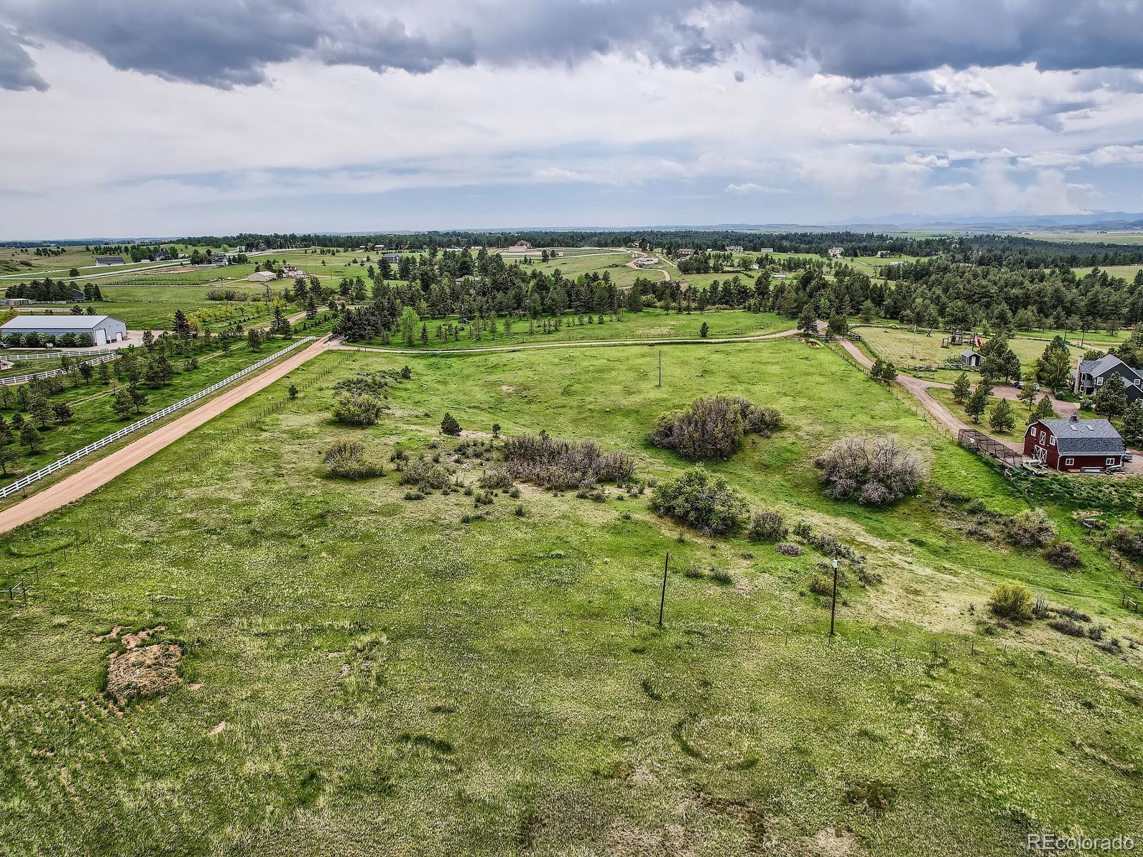 104 Bill Davis Road Franktown, CO 80116 - Photo 7 of 14 a view of a city with lush green forest